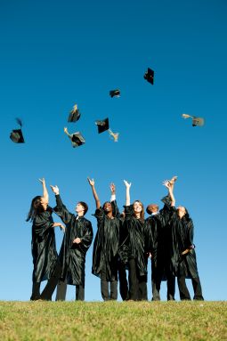 photo of graduates throwing caps