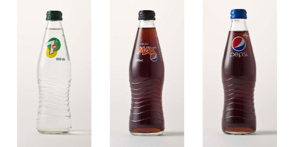 Photo of 3 Pepsi Cola bottles, showing their shape.