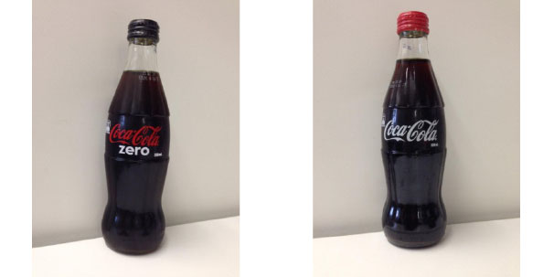 Photo of 2 Coca Cola bottles, showing their shape.